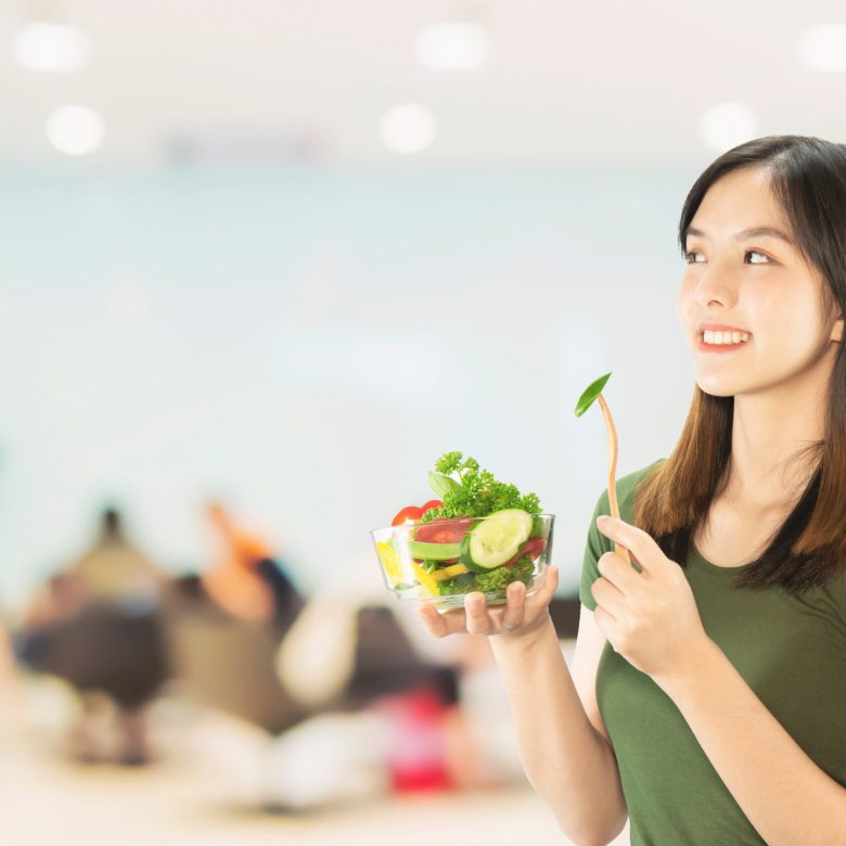 Happy lady holding kichen stuff over copy space background - people home made food preparation concept